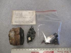 Yttrialite-(Y) with Biotite and Feldspar and white coating
